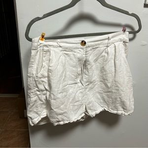 White linen shorts with brown button